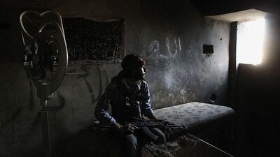 A member of the Shohadaa Badr Brigade, which operates under the Free Syrian Army, sits on a bed in Ashrafieh, Aleppo. Muzaffar Salman / Reuters