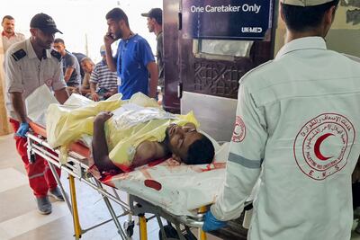 A Palestinian man wounded while trying to get aid is taken for treatment at Nasser Hospital in Khan Younis. AFP