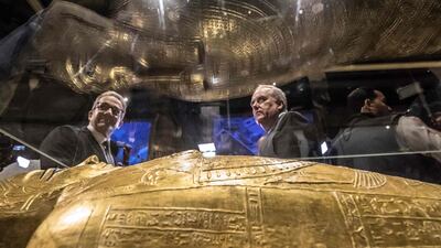 Khaled El-Enany and Thomas Goldberger look at the coffin. AFP