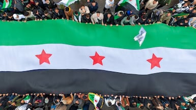 Hundreds of people gathered in Umayyad Square in Damascus celebrate the anniversary of the fall of the Assad regime. AFP