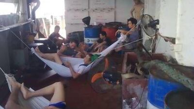 Crew members rest outside their cabins because of the unbearable heat inside.