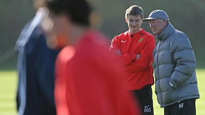 Manchester United football club manager Sir Alex Ferguson, right, talks with Ole Gunnar Solskjaer during a team training session in 2007. Solskjaer is set to become the new Cardiff City manager. AFP PHOTO/PAUL ELLIS