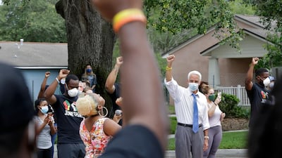 US Representative Charlie Crist, second from right, stands in solidarity with guests during a Juneteenth 2020 celebration in Florida. AP Photo