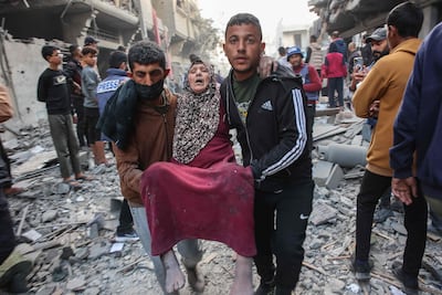 An injured woman is evacuated after an Israeli strike in Gaza City's Sabra neighbourhood on Tuesday. AFP