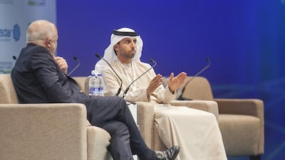 Suhail Al Mazrouei, the Minister of Energy, right, discusses a point during the opening day of the World Future Energy Summit. Mona Al Marzooqi / The National