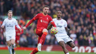 Liverpool midfielder Jordan Henderson is challenged by Brentford striker Ivan Toney. AP