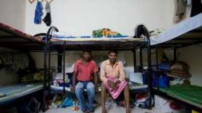 Workers sit in their room in a labour camp for Indians and Bangladeshi workers. They are carpenters working in Saadiyat Island.