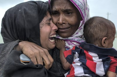 Rohingya Muslim refugees rare re-united after arriving on a boat from Myanmar on September 08, 2017 in Whaikhyang Bangladesh. Getty