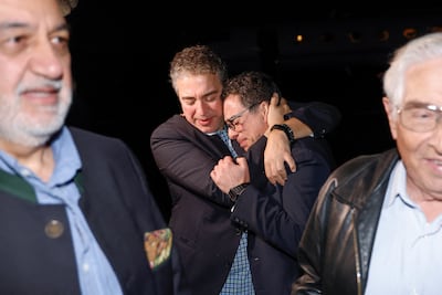 Siamak Namazi is embraced by a family member after arriving in the US following his release from Evin Prison. AFP