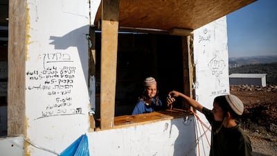 Jewish settler children play in a provisonary kiosk at Eviatar.