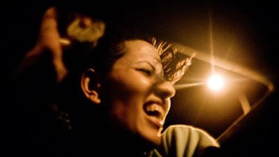 On the way back from a visit to Jericho, Mona Ennab climbs out of the sunroof of her boyfriend’s car and shouts at an Israeli checkpoint.