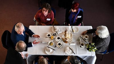 King Charles III (left) takes afternoon tea with Age UK volunteers and service users, during a visit to Colchester Library, on March 7.
