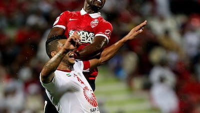 According to Eisa Santo, the weather is same for local players such as Al Ahli’s Ismail Al Hammadi, in red, as it is for Sharjah’s Brazilian Mauricio Ramos. Satish Kumar / The National