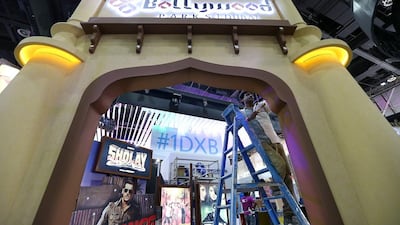 Above, final preparations in full swing for the Dubai Parks and Resorts’ stand at the Arabian Travel Market event this year. Pawan Singh / The National