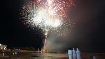 Attendees watch the fireworks display on Mirfa Beach at the Al Gharbia Watersports Festival.