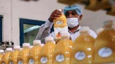 A worker checks Masafi juice before it moves on in the Masafi plant in Fujairah.