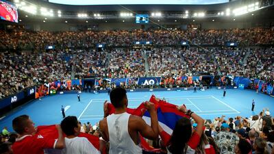 Fans of Novak Djokovic cheer. EPA