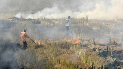 Farmers in India burn straw stubble in a village in November. Narinder Nanu / AFP