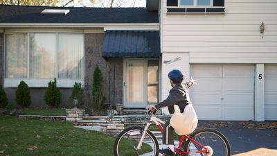 Boy delivering newspapers on his bicycle. Getty Images
