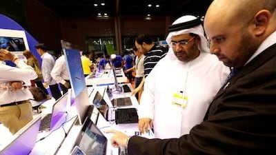 Dubai, United Arab Emirates- April, 03, 2013: Visitors browses the latest Laptops at the Samsung store during the Gitex Shoppers-2013 at the Dubai World Trade Centre in Dubai . ( Satish Kumar / The National ) For Business