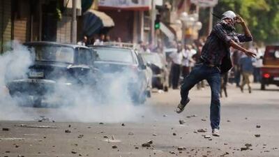 Egyptian riot police fire tear gas as supporters of ousted president Mohammed Morsi clash with residents and police in downtown Cairo.