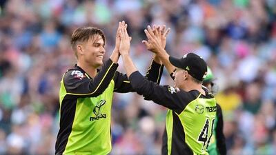 Sydney Thunder cricketer Chris Green, left, celebrates with teammate Michael Hussey after taking the wicket of Peter Handscomb of the Melbourne Stars during the T20 Big Bash League cricket final between the Melbourne Stars and Sydney Thunder at the Melbourne Cricket Ground in Melbourne on January 24, 2016. Theo Karanikos / AFP