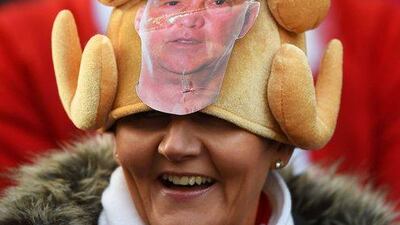 A fan wears a Christmas turkey hat with a picture of Louis van Gaal on Saturday during Manchester United’s match at Stoke City. Laurence Griffiths / Getty Images