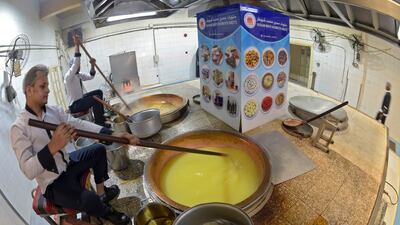 Workers prepare Halwa, a Bahraini sweet made primarily from sugar, corn starch, saffron and nuts at Hussain Showaiter Sweets at the Muharraq island store in northern Bahrain.