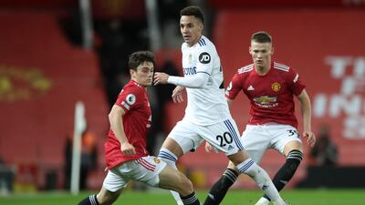Rodrigo of Leeds in action against Daniel James and Scott McTominay of Manchester United. EPA