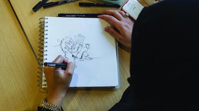 Asma Saeed draws her manga character Asami. Mona Al-Marzooqi / The National