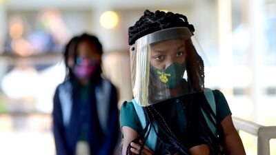 Victoria Dickens wears a mask and face shield as she waits for her class assignment at Summit Elementary School in Summit, Mississippi on August 5, 2021, during the first day of the 2021-22 school year. AP