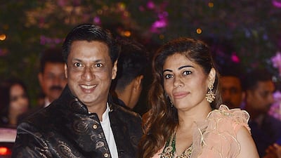 Indian Bollywood film director and producer Madhur Bhandarka poses for a picture with his wife as they attend the engagement party of India's richest man and Reliance Industries Limited Chairman, Mukesh Ambani’s eldest son Akash Ambani and fiancee Shloka Mehta, in Mumbai late on June 30, 2018. AFP