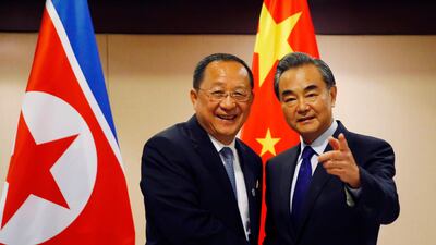 North Korean foreign minister Ri Yong Ho (L) is greeted by his Chinese counterpart, Wang Yi, prior to their bilateral meeting on the sidelines of the 50th ASEAN Foreign Ministers' Meeting and its Dialogue Partners on Sunday in suburban Pasay city, south Manila, Philippines. AP / Bullit Marquez