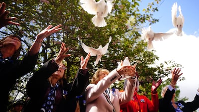White doves are released in St James's Square. PA