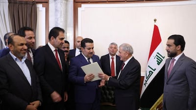 Newly elected Iraqi President Abdul Latif Rashid, second right, designates Mohammed Shia Al Sudani to form a new government. Reuters