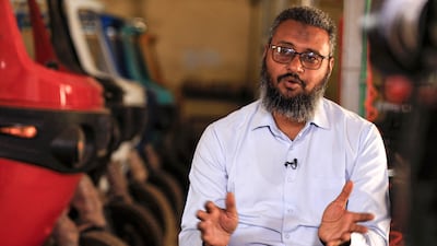 Mohamed Samir, owner of al-Shehab factory, gives an interview at his plant, extolling the virtues of electric tuk-tuks.