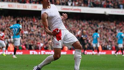 Robin van Perise celebrates scoring his second goal from a free kick to earn Arsenal a 2-1 win against Sunderland. Paul Gilham / Getty Images