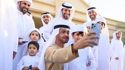 President Sheikh Mohamed takes a selfie with the family of Emirati poet Ahmed Al Mansoori at his home in Al Wathba. All photos: Presidential Court