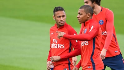 Neymar, left, and Kylian Mbappe both arrived at Paris Saint-Germain last summer and will eventually cost the club a reported €367m combined. Christophe Simon / AFP