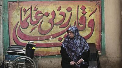 An Egyptian woman waits for an election worker to check her identification card inside a polling centre d in the Maadi district of Cairo. Nariman El Mofty / AP Photo