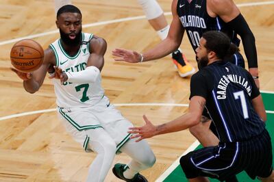 Boston Celtics' Jaylen Brown, left, passes off against Orlando Magic's Michael Carter-Williams. AP