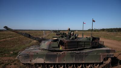 Polish soldiers sit on top of an Abrams tank before an annual artillery show near Orzysz, Poland. Reuters