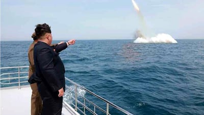 North Korean leader Kim Jong-un cheers the launch of a ballistic missile. EPA