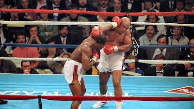 19 Apr 1991: Evander Holyfield lands a left punch during a fight against George Foreman in Atlantic City, New Jersey. Getty