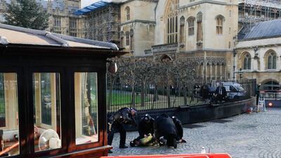 A man is detained by police. AFP