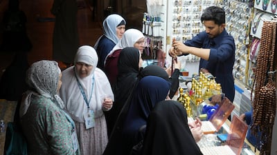 Pilgrims buy souvenirs at a shop outside the Grand Mosque. AP