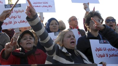 People demonstrate outside the Tunisian parliament, in Tunis on Saturday, December 24, 2016 against the return of Tunisian extremists who have fought abroad. The gathering was prompted by the deadly truck attack in a Berlin Christmas market by Tunisian Anis Amri, who had pledged allegiance to ISIL. AP Photo