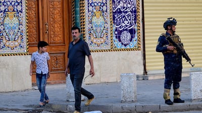 A member of Iraqi federal police forces stands guard infront of a Mosque in Baghdad. EPA
