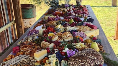 An outdoor grazing table set up by All That Platters, a catering company specialising in “perfect platters and amazing grazing” based in New South Wales, Australia, where the trend originated