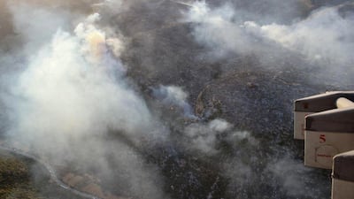 A handout picture released by the official Syrian Arab News Agency (SANA) shows smoke billows from fire in al-Hayluna village, in the western countryside of Syria's Hama governorate. AFP